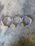 Purple, White, and Gold Bracelets